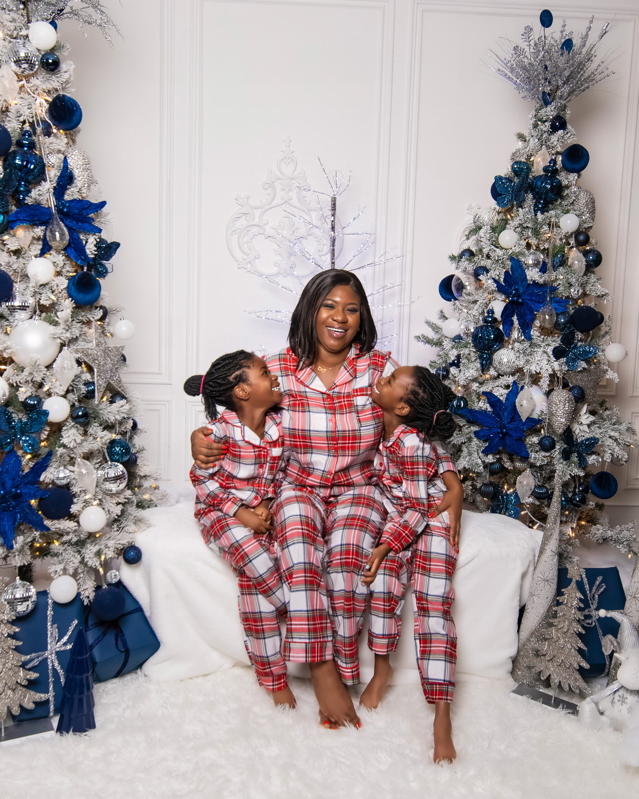 Mother and two daughters posing for a Christmas photoshoot